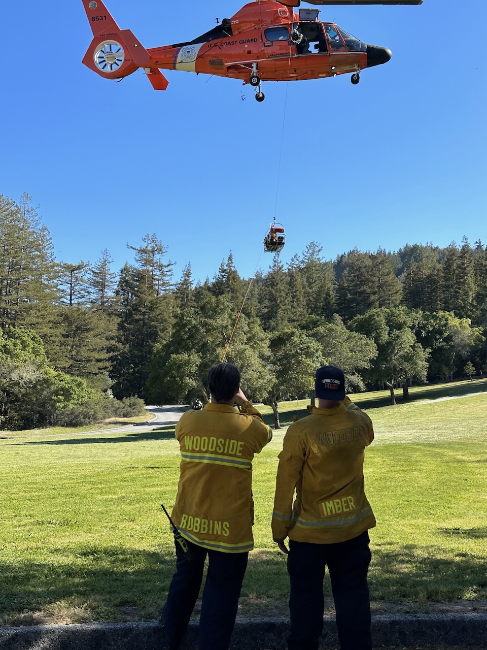 Fire crew communicating with a Coast Guard chopper